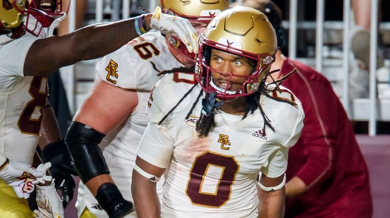 Boston College running back Treshaun Ward (0) celebrates with teammates...