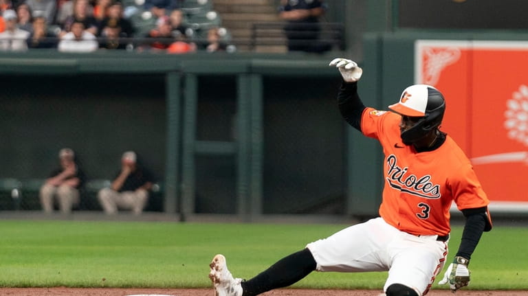 Baltimore Orioles' Jorge Mateo (3) slides into second base with...