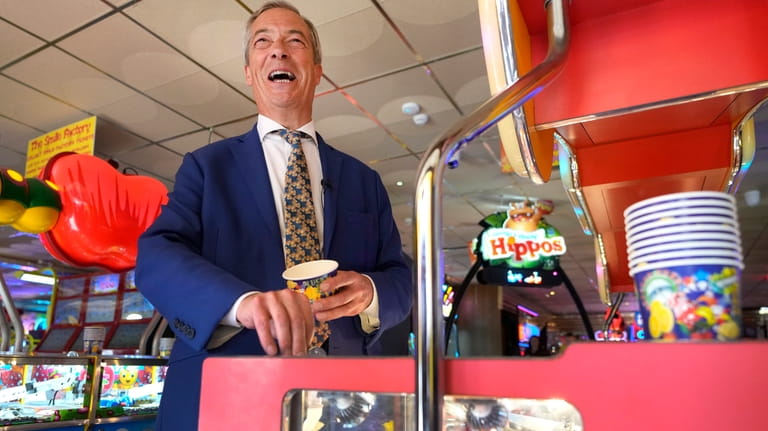 Britain's Nigel Farage, Reform UK party leader plays on a...