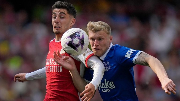 Arsenal's Kai Havertz, left, and Everton's Jarrad Branthwaite battle for...