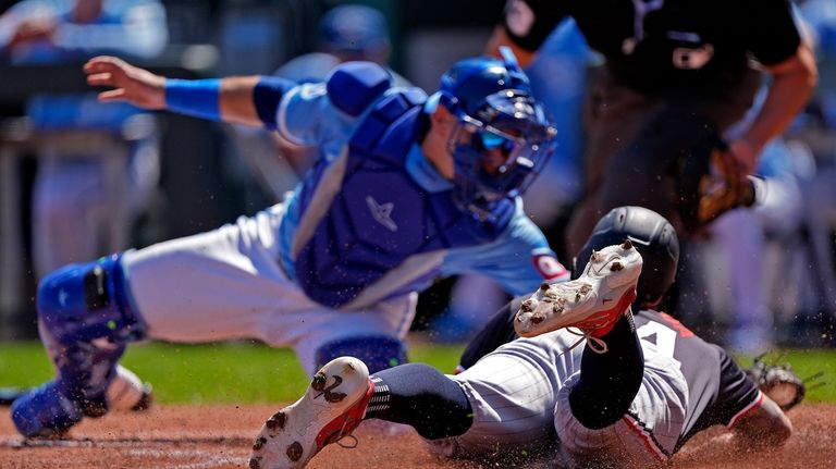 Minnesota Twins' Jose Miranda is tagged out at home by...