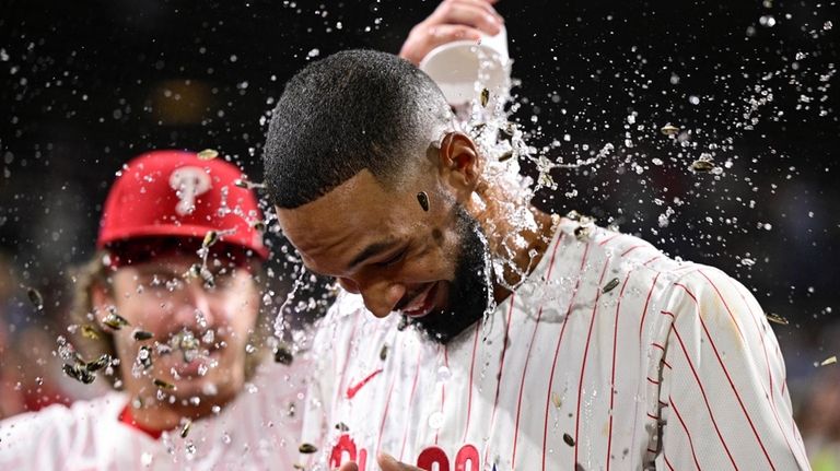 Philadelphia Phillies' Cristopher Sánchez is doused by teammates after a...