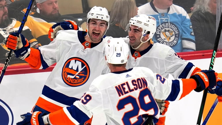 The Islanders' Adam Pelech celebrates his game-winning goal in overtime...