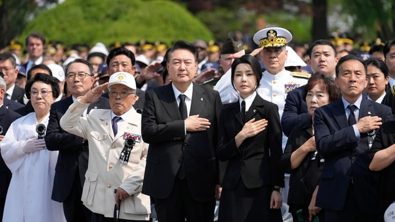 South Korean President Yoon Suk Yeol, center left, and his...