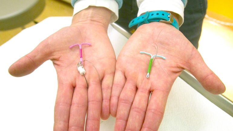 Dr. Susan Gorman displays the Skyla IUD, left, and the...