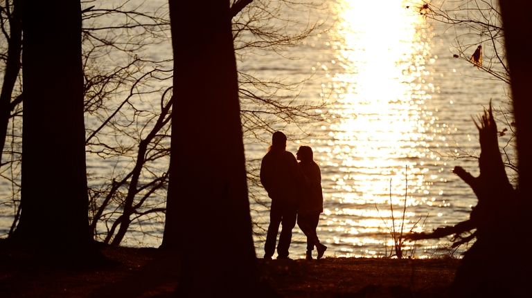 A couple stands at the banks of the Loch Raven...