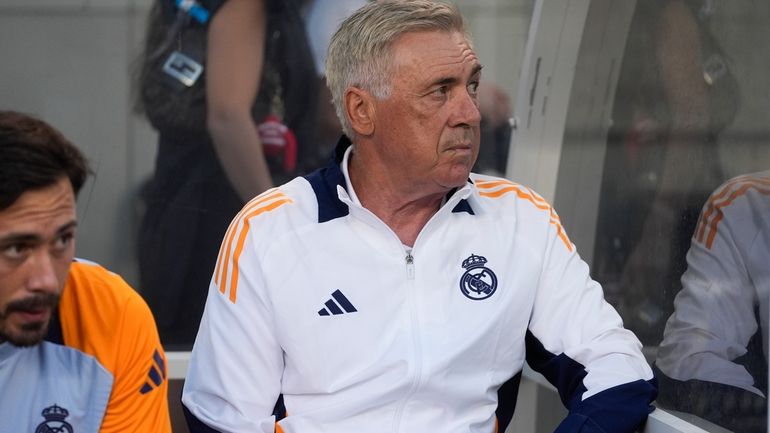 Real Madrid coach Carlo Ancelotti sits on the bench before...