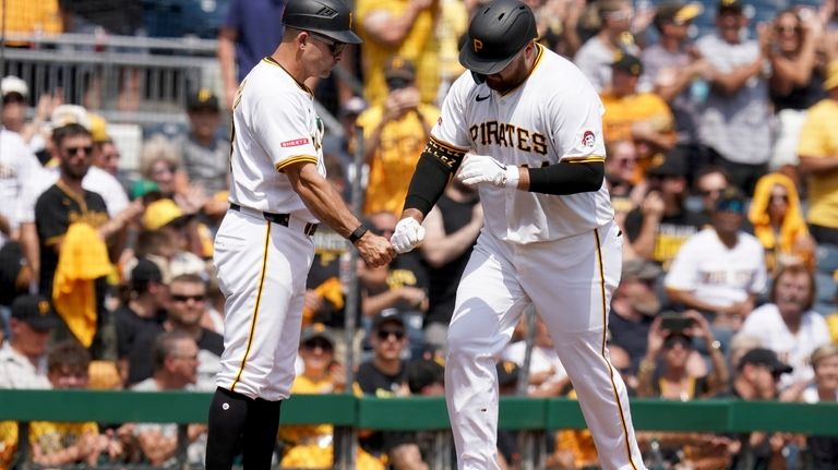 Pittsburgh Pirates' Rowdy Tellez, right, is greeted by third base...