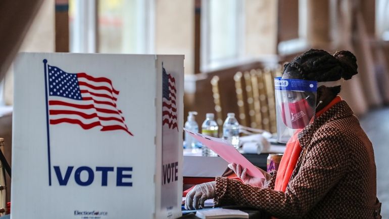 A poll worker sorts through voting material at Park Tavern...