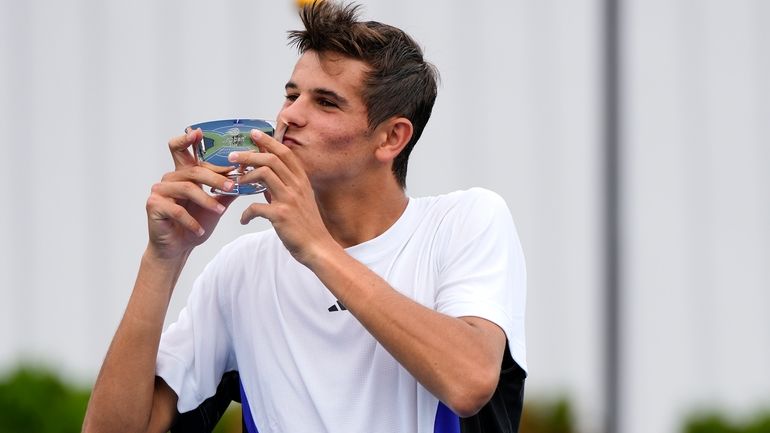 Rafael Jodar, of Spain, holds up the championship cup after...