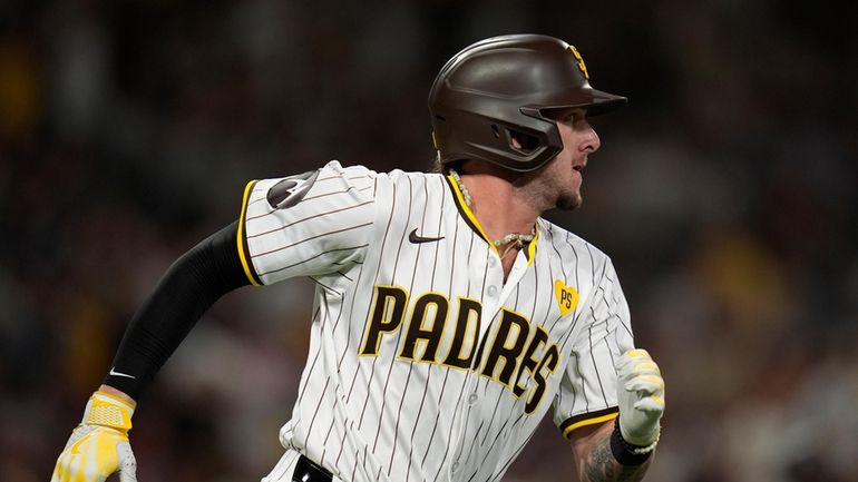 San Diego Padres' Jackson Merrill watches his three-RBI double during...