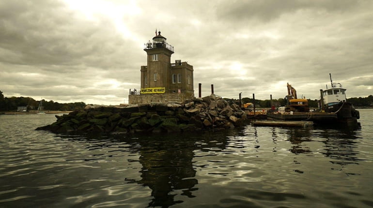 The historic Huntington Lighthouse marks the mouth of Huntington Harbor....