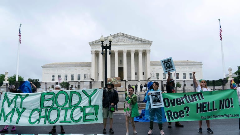 Abortion-rights activists protest outside of the Supreme Court on Capitol...