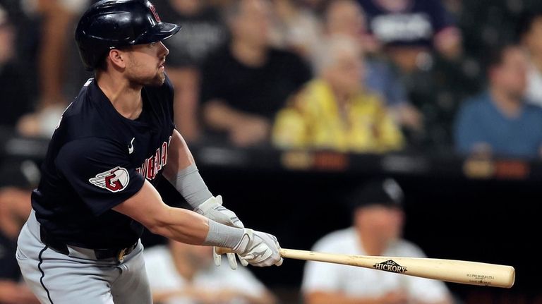 Cleveland Guardians' Lane Thomas watches his three-run home run during...