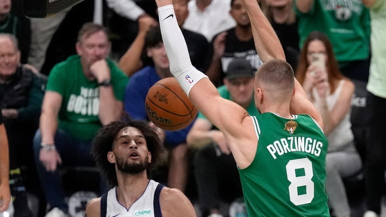 Boston Celtics center Kristaps Porzingis (8) dunk in front of...