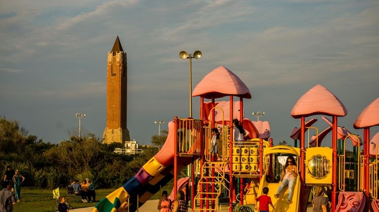 Children play on the playground at Jones Beach. The park...