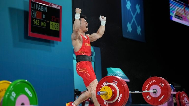 Li Fabin of China reacts as he competes during the...