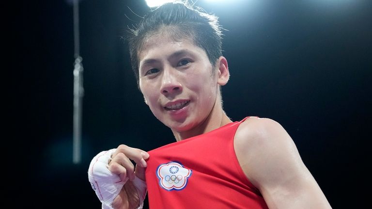 Taiwan's Lin Yu-ting celebrates after defeating Bulgaria's Svetlana Staneva in...