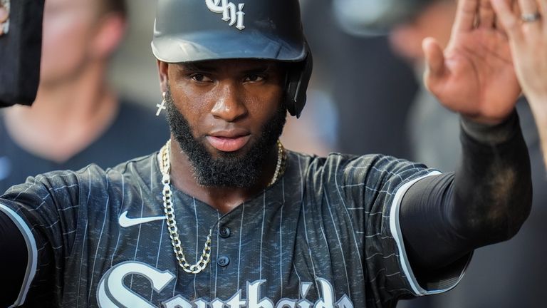 Chicago White Sox's Luis Robert Jr. celebrates after scoring on...