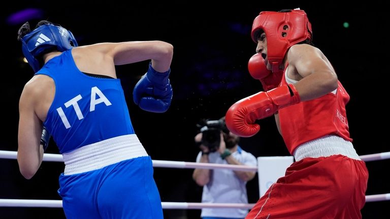 Algeria's Imane Khelif, right, fights Italy's Angela Carini in their...