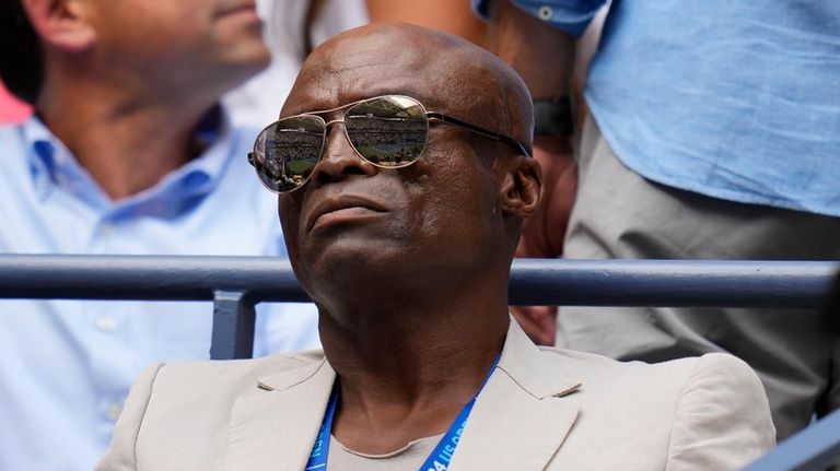 Seal watches the men's singles semifinals between Jannik Sinner, of...