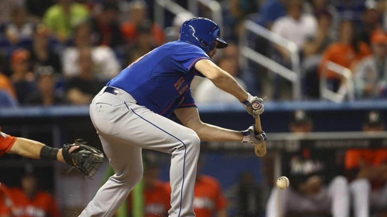 The Mets' Jon Niese bunts and brings a run home...