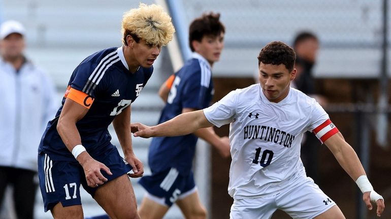 Smithtown West midfield Gavin Reis looks to dribble the ball...