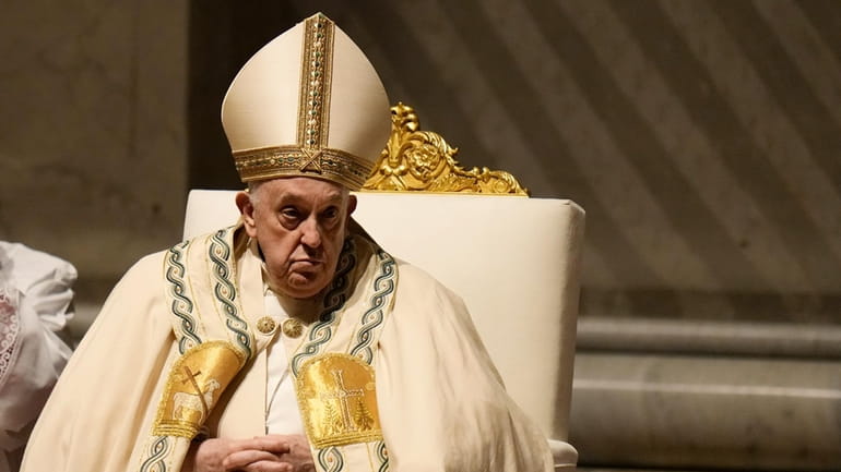 Pope Francis presides over the Easter vigil celebration in St....