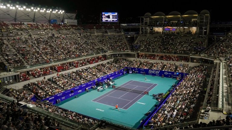 Casper Ruud of Norway, top, plays against Alex de Minaur...