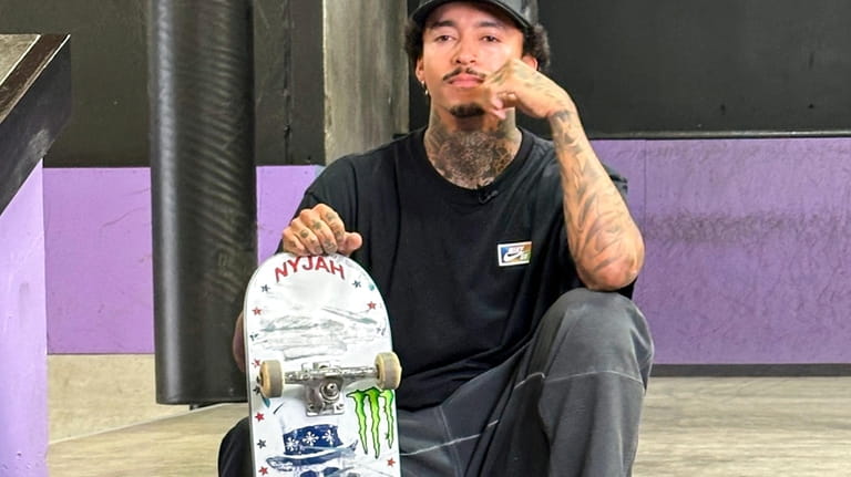 Nyjah Huston poses with his board at his private skate...