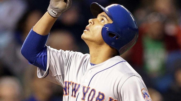 The Mets' Ruben Tejada celebrates after hitting a solo home...