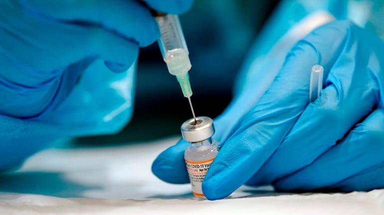 A nurse prepares the Pfizer-BioNTech Covid-19 vaccine for children for...