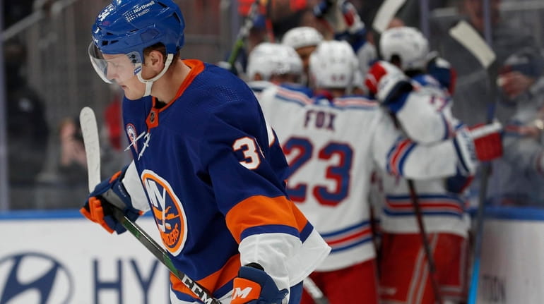 Paul LaDue #34 of the New York Islanders skates away...