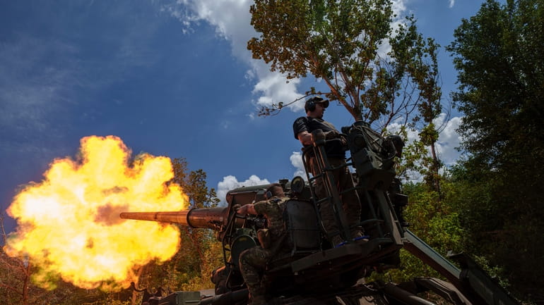 Ukrainian soldiers, of 43rd artillery brigade, fire by 2s7 self-propelled...