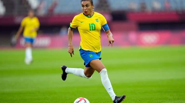 Brazil's Marta dribbles the ball during a women's soccer match...