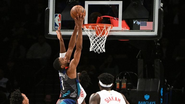 Nets forward Mikal Bridges shoots past Toronto Raptors forward O.G....