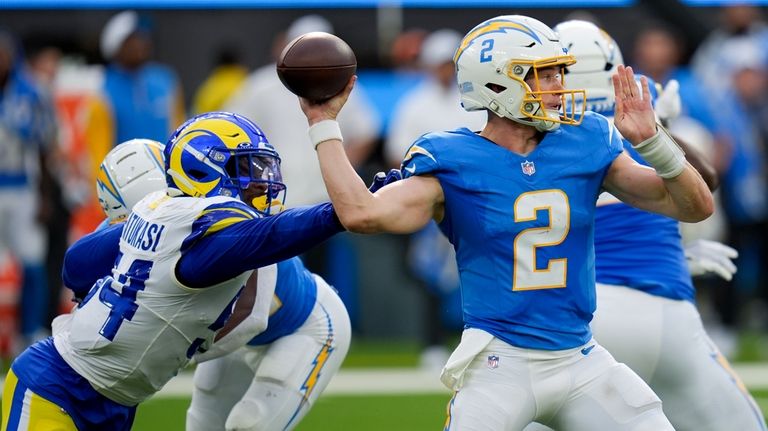 Los Angeles Chargers quarterback Easton Stick (2) throws under pressure...