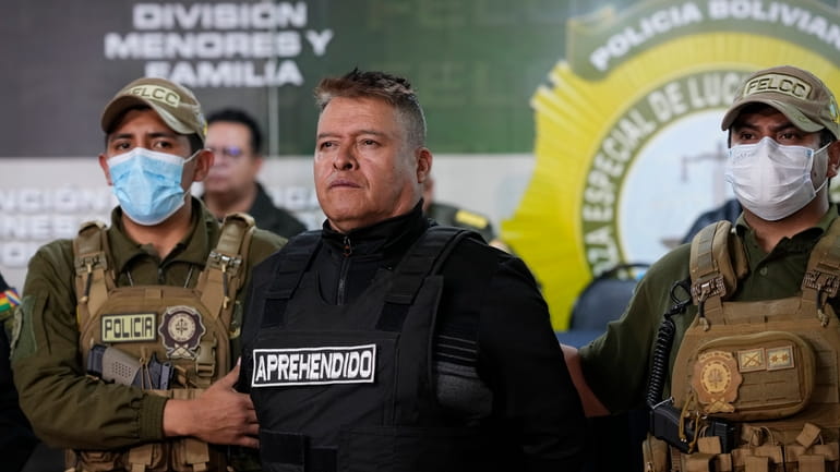 Bolivian police hold the detained Juan Jose Zuniga, former general...