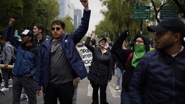 Demonstrators protest outside the Senate against the judicial reform bill...