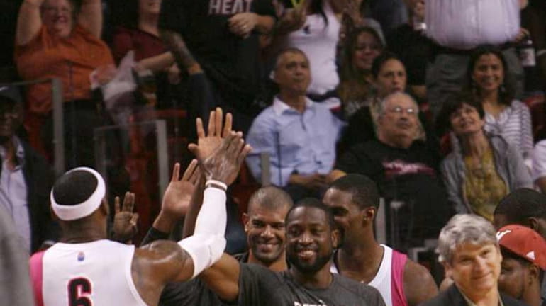 Miami Heat's LeBron James celebrates with teammates, from left, Shane...