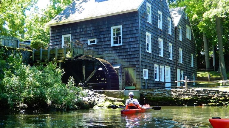 A kayaker rests near the Grist Mill in Stony Brook,...