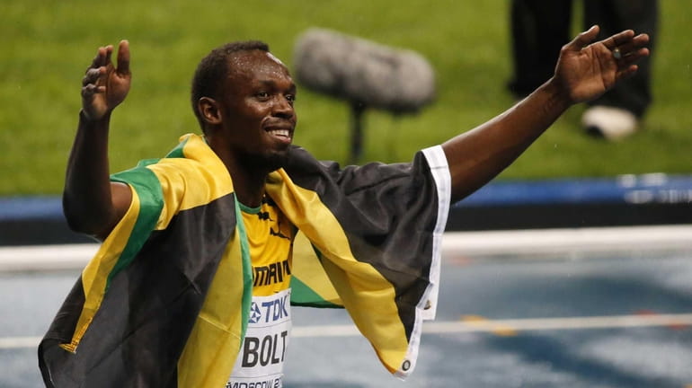 Jamaica's Usain Bolt celebrates after winning gold in the men's...