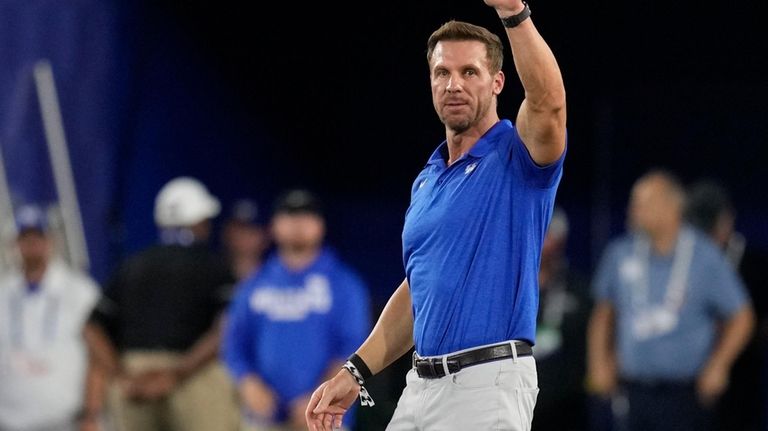 Former Kentucky quarterback Tim Coucz waves to fans after being...