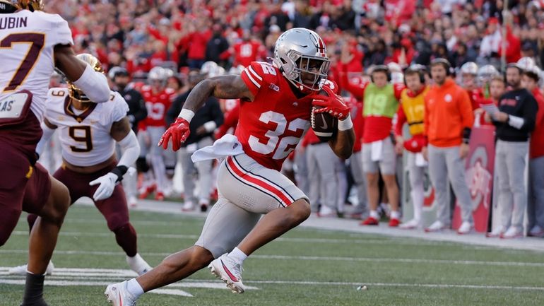 Ohio State running back TreVeyon Henderson plays against Minnesota during...