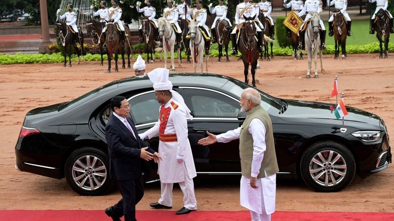 Indian Prime Minister Narendra Modi, right, receives his Vietnamese counterpart...