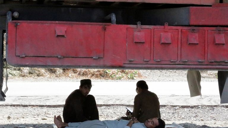 Drivers sleep under their truck and wait to the opening...