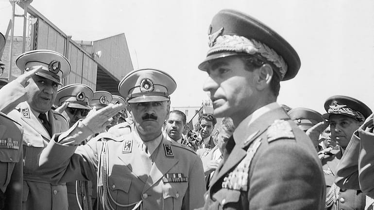 Shah Reza Pahlevi, of Iran, is saluted by an honor...