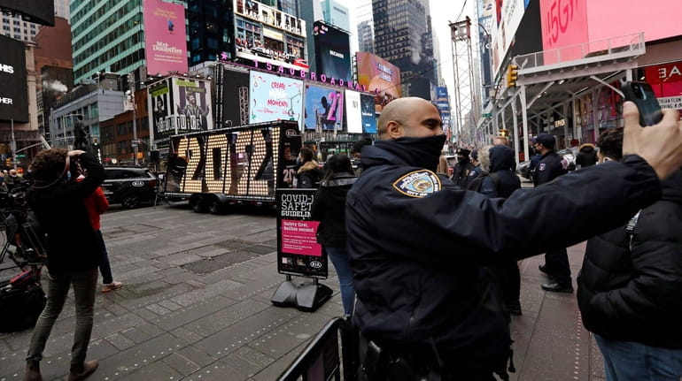 A NYPD officer takes a picture of the 2021 light bulb...