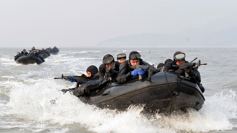 South Korean and United States marines ride on inflatable boats...