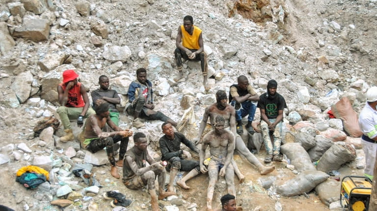 Miners take a break during the mine rescue mission on...